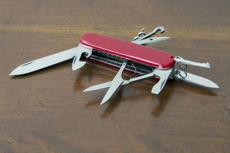 swiss army knife opened with many tools available