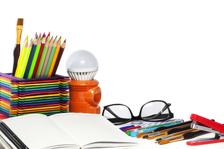 Stationery background - Group of stationery tools -  color pencils, notebooks, glasses , stapler , pens, brushes on white backgroundの写真素材