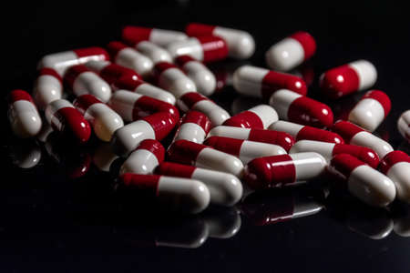 Capsules scattered on a black table