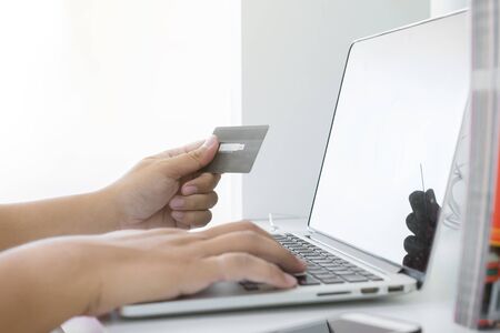 Businessman doing online shopping Hand holding credit card and using laptop. Online shopping concept