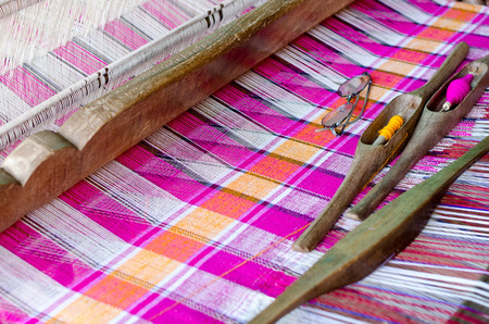 Women in rural areas of Thailand are usually small weaving loom. Woven fabric is not finished.の写真素材