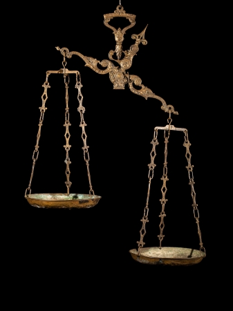 Antique rusty weighing scale isolated on blackの写真素材