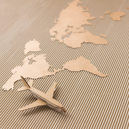 Airplane and world map made of cardboard  Square format, selective DOFの写真素材