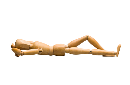 Wooden mannequin lying down, isolated on white.の写真素材