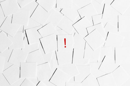 Pile of blank pieces of paper with red exclamation mark in the middleの写真素材