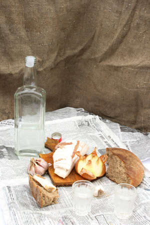 On a photo vodka, bacon and bread.の写真素材