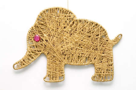 The New year's toy. Elephant and threads with stone instead of eyeの写真素材