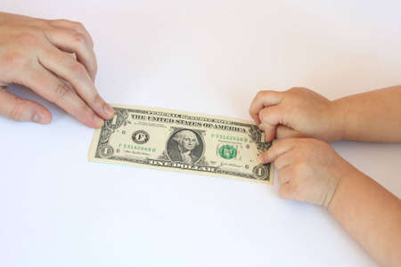 dollar bill in hand of the ma and childの写真素材