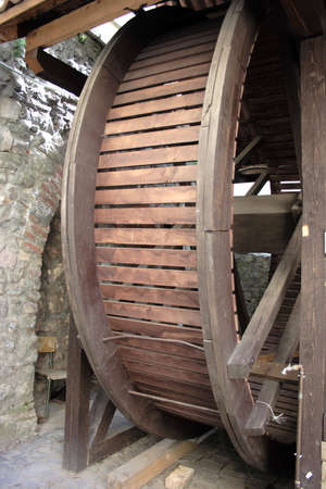 A wooden well is in an age-old fortress