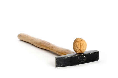 Nut and  hammer isolated on whiteの写真素材