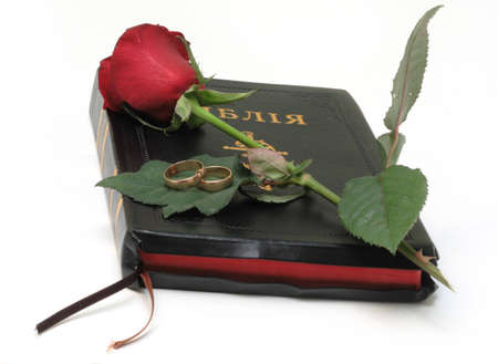 Bible and red rosa isolated on whoteの写真素材