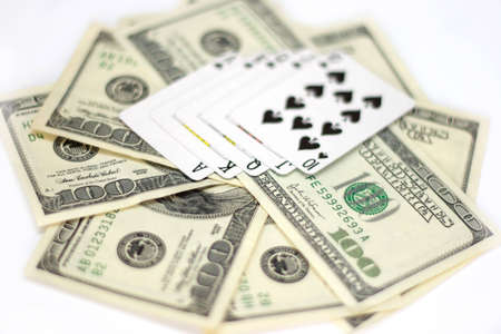 Playing cards and dollars bills isolated on white