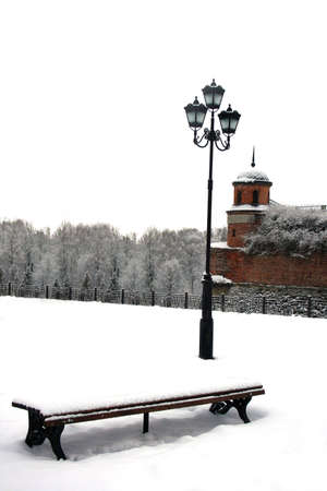 bench and lamp against the backdrop of the towers of a medieval castle in Dubno, Ukraineの写真素材