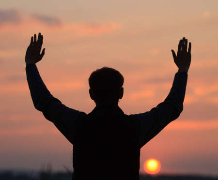 Man looks at the sunset.