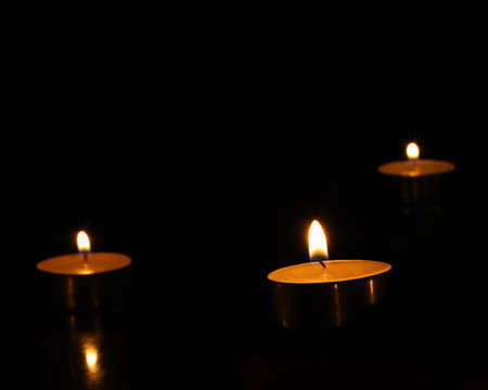 three candles rice on the black backgroundの写真素材