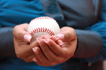 baseball in woman handの写真素材