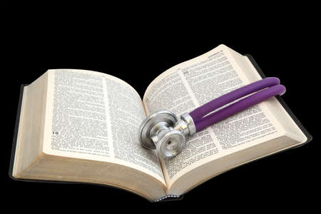 The Bible and the stethoscope on white backgroundの写真素材