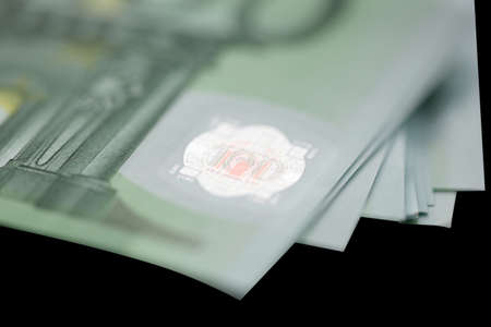 Euro bills on black background