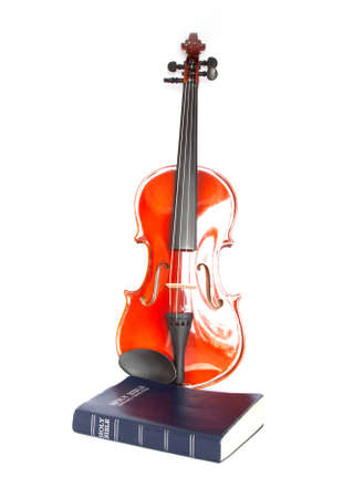 violin with holy Bible isolated on whiteの写真素材