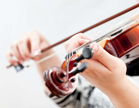 Musician playing violin isolated on whiteの写真素材