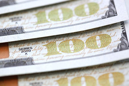 100 dollar bills isolated on white background closeup