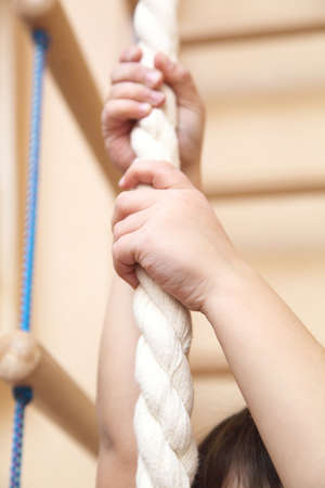 child holding a hand rope
