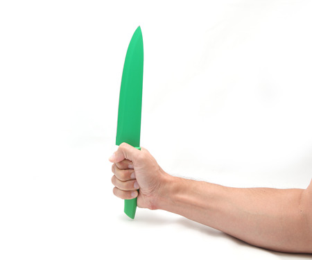 Knife in hand isolated on whiteの写真素材