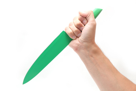 Knife in hand isolated on whiteの写真素材