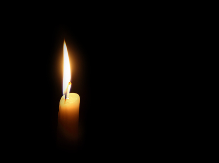 candle burning on a dark backgroundの写真素材