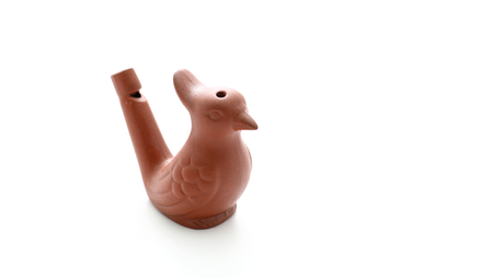clay whistle in the bird shape on tableの写真素材