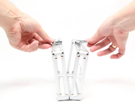 Hands open the glass case on a white background