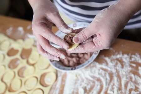 woman preparing dumplings hands