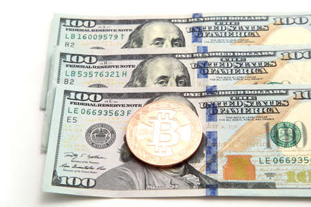 gold coin bitcoin on dollar billsの写真素材