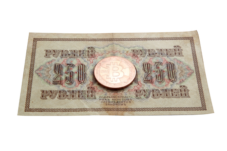 on the photo 250 ancient Russian rubles and on them a bitcoin coin. It will become new in the financial systemの写真素材