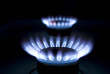 Blue flames of gas stove in the dark