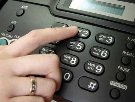 Finger presses figure on phone                                 