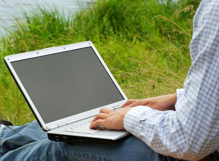 male hands typing on a laptopの写真素材