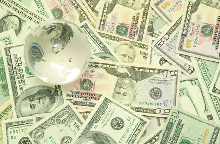 globe isolated on a dollars backgroundの写真素材