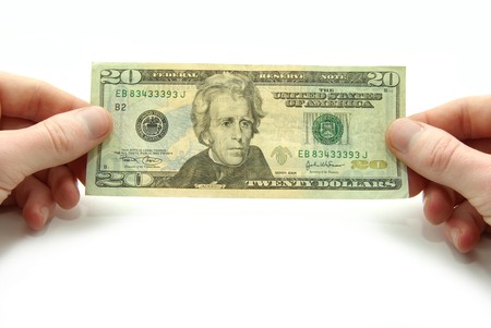 Hands hold 20 bill on white background