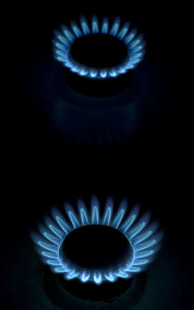 Blue flames of gas stove in the dark