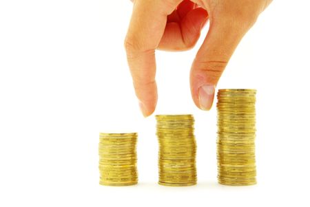 Hand put coin to money staircase isolated on white backgroundの写真素材