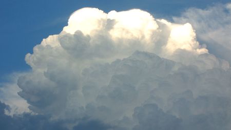 Blue sky background with a tiny clouds                               