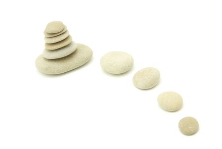 Stack of balanced stones on a white backgroundの写真素材