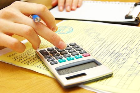 Closeup of a young women calculating bills
