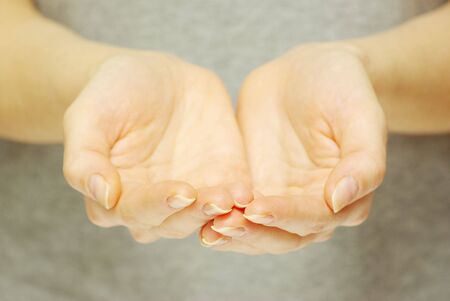 A hands begging alms on a grey backgroundの写真素材