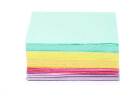 Batch of assorted color paper over white background
