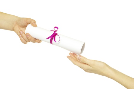 Diploma with a red ribbon in hand isolated on white の写真素材