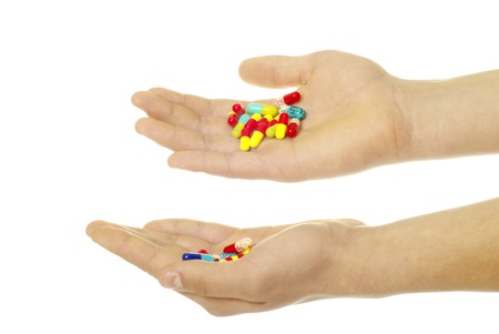 finger holds pill isolated on whiteの写真素材