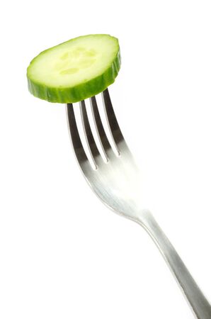 fresh cucumber on a forkの写真素材
