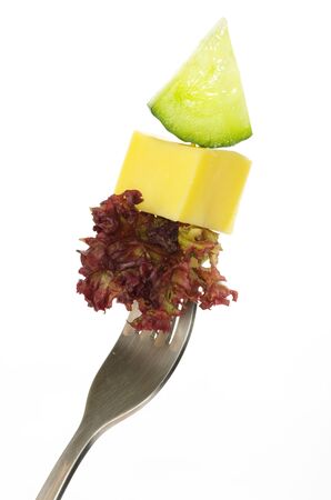 Fresh vegetables on a fork isolated on white backgroundの写真素材